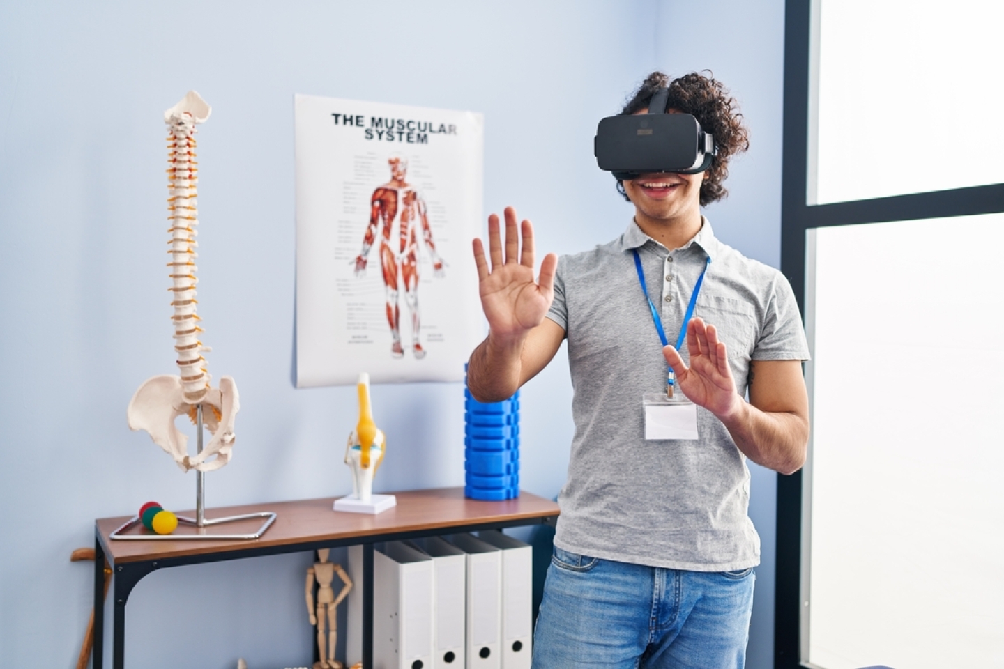 Young hispanic man physiotherapist using virtual reality glasses at rehab clinic