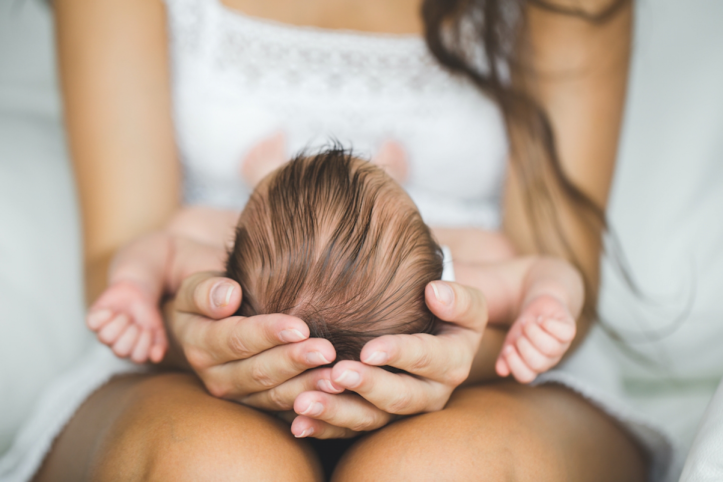 mother holding baby in her hands