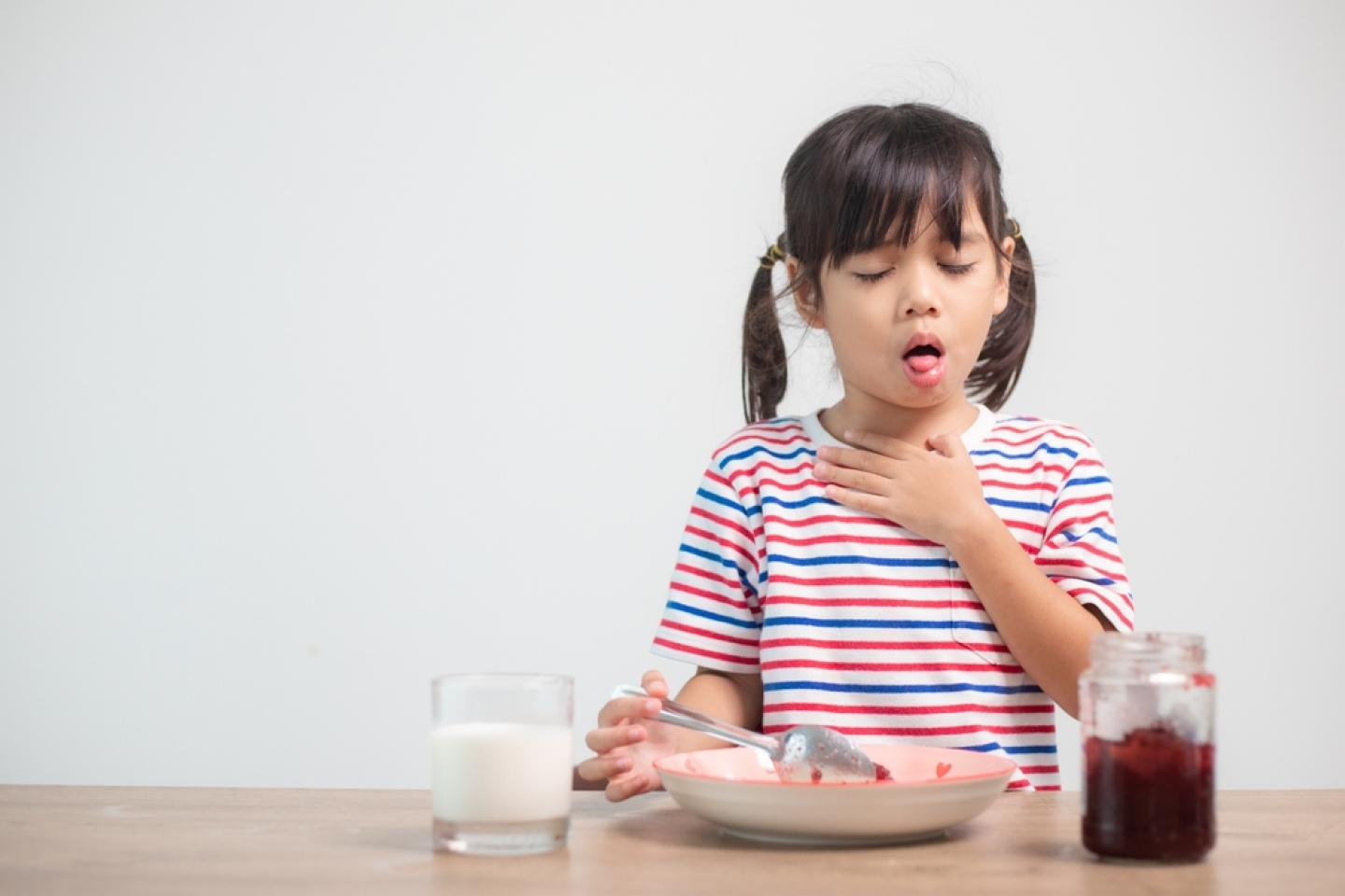 girls eating bread and desserts and sticking in one's throats with choked food