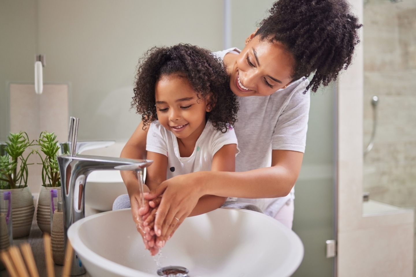 washing hands and child with mom rinsing