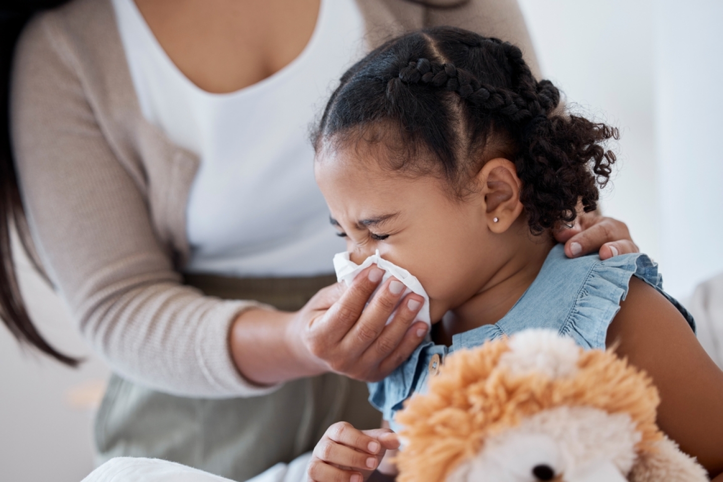 Mother clean sick child nose with tissue