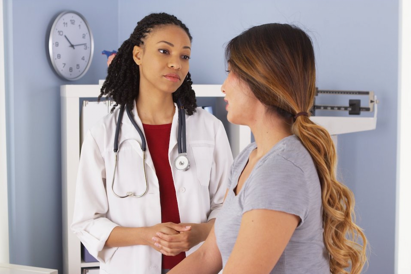 black female doctor meets with female patient