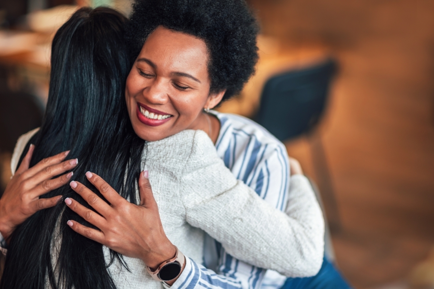 Support group patients hug each other during the therapy session. Group therapy session, addiction treatment or team building.