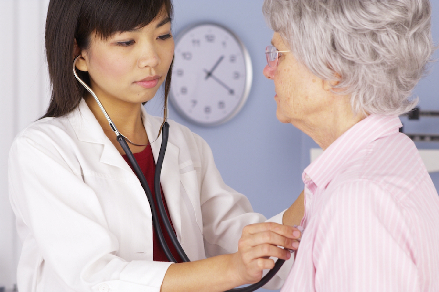 doctor checks on patient's heart