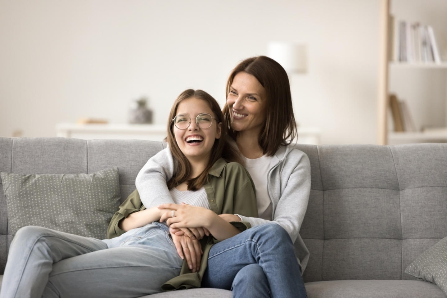 Happy mom and teenager daughter home casual portrait.