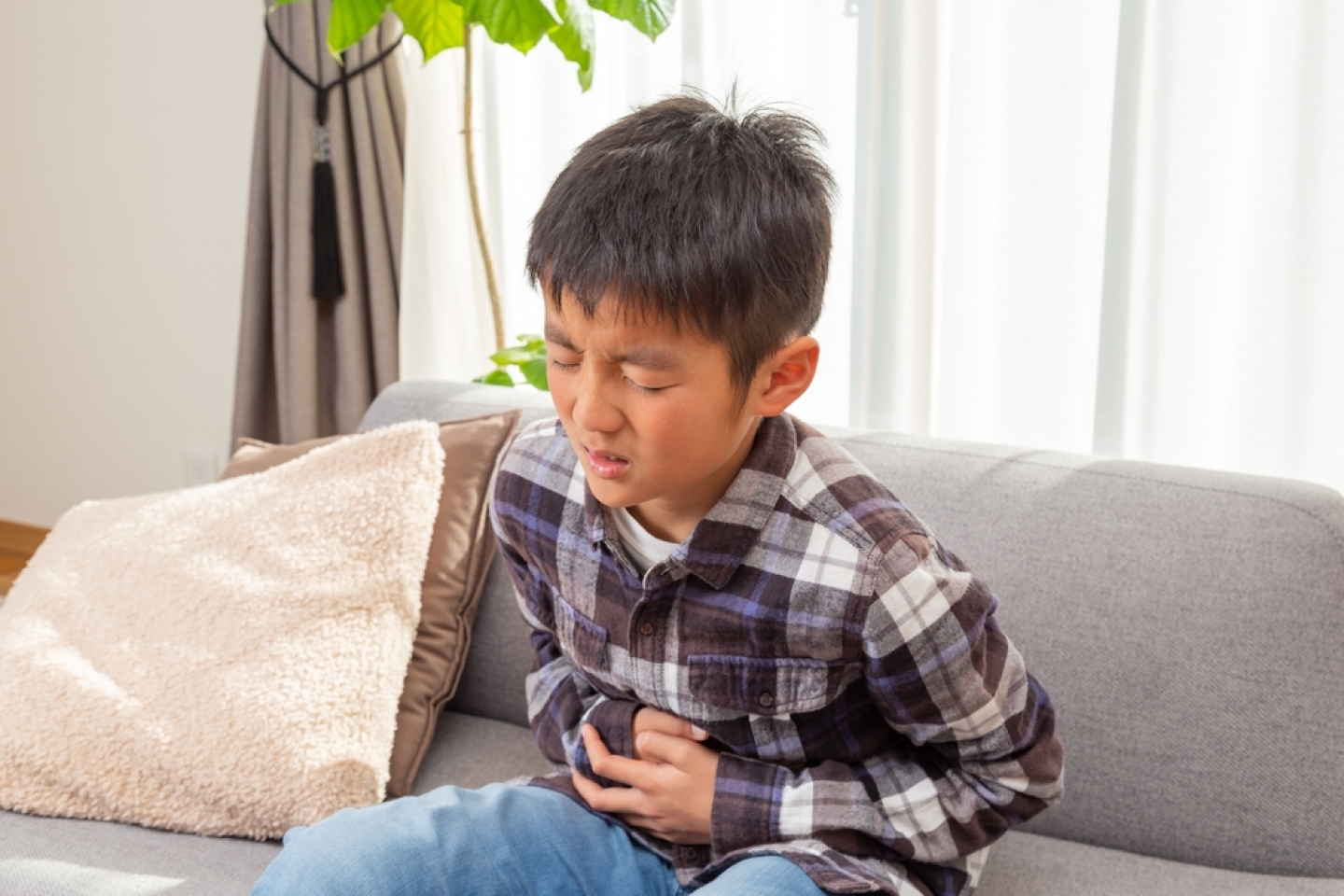 A boy suffering from stomach pain.