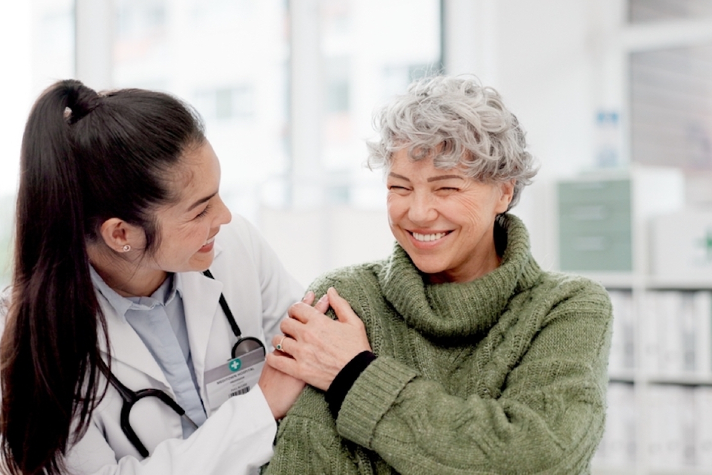 Happy, care and face of a doctor with a woman for medical trust, healthcare and help.