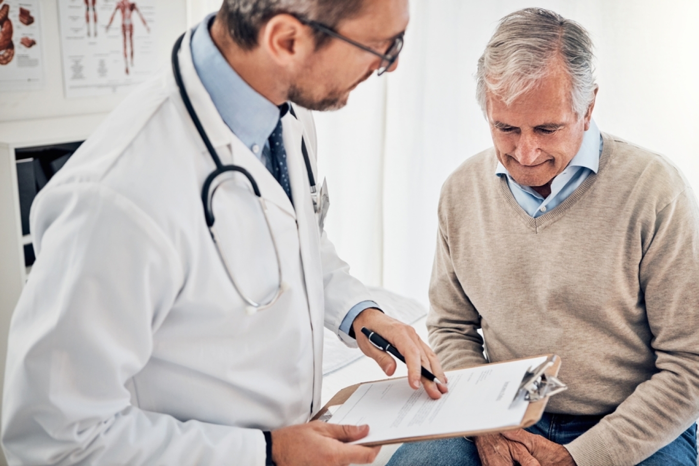 older man speaks with doctor