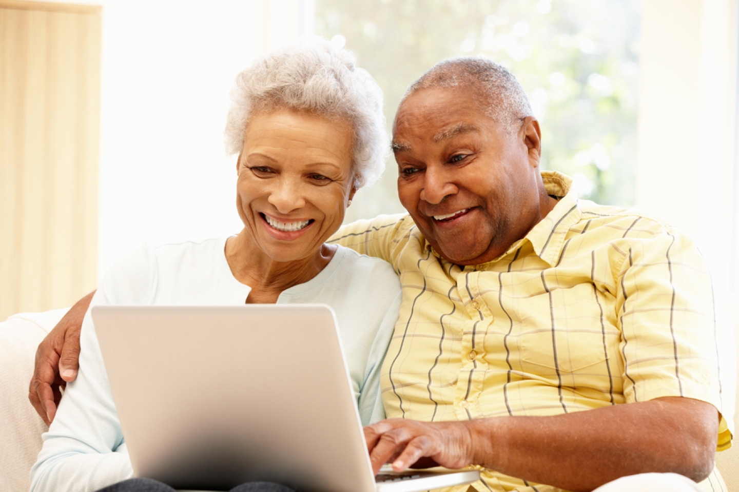 Senior African American couple using laptop