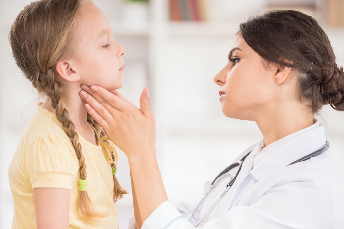 checking younger patient for neck bumps