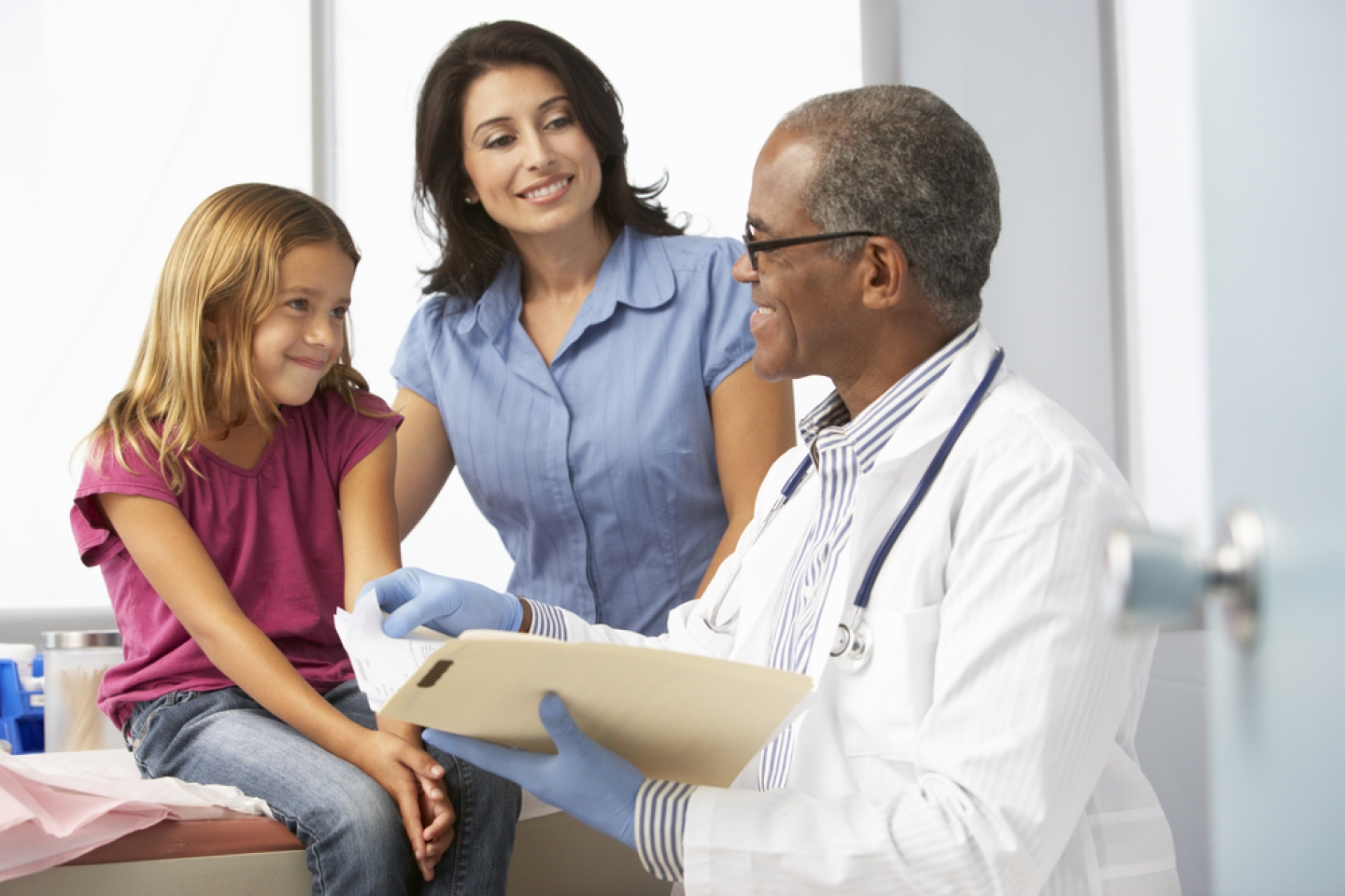 Doctor In Surgery Examining Young Girl