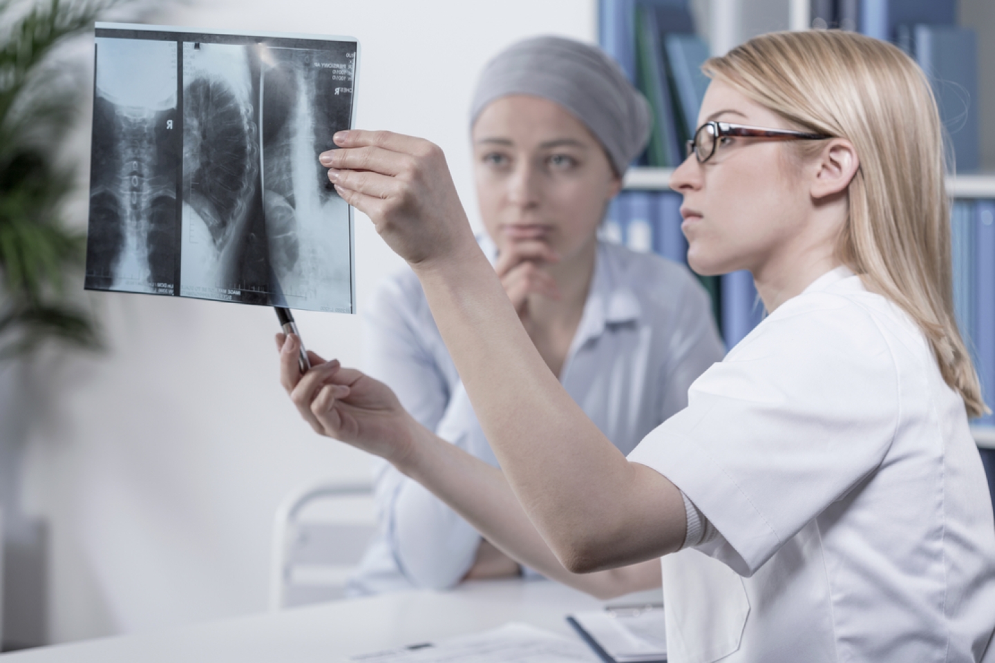 Young doctor looking at her patient's xray photo