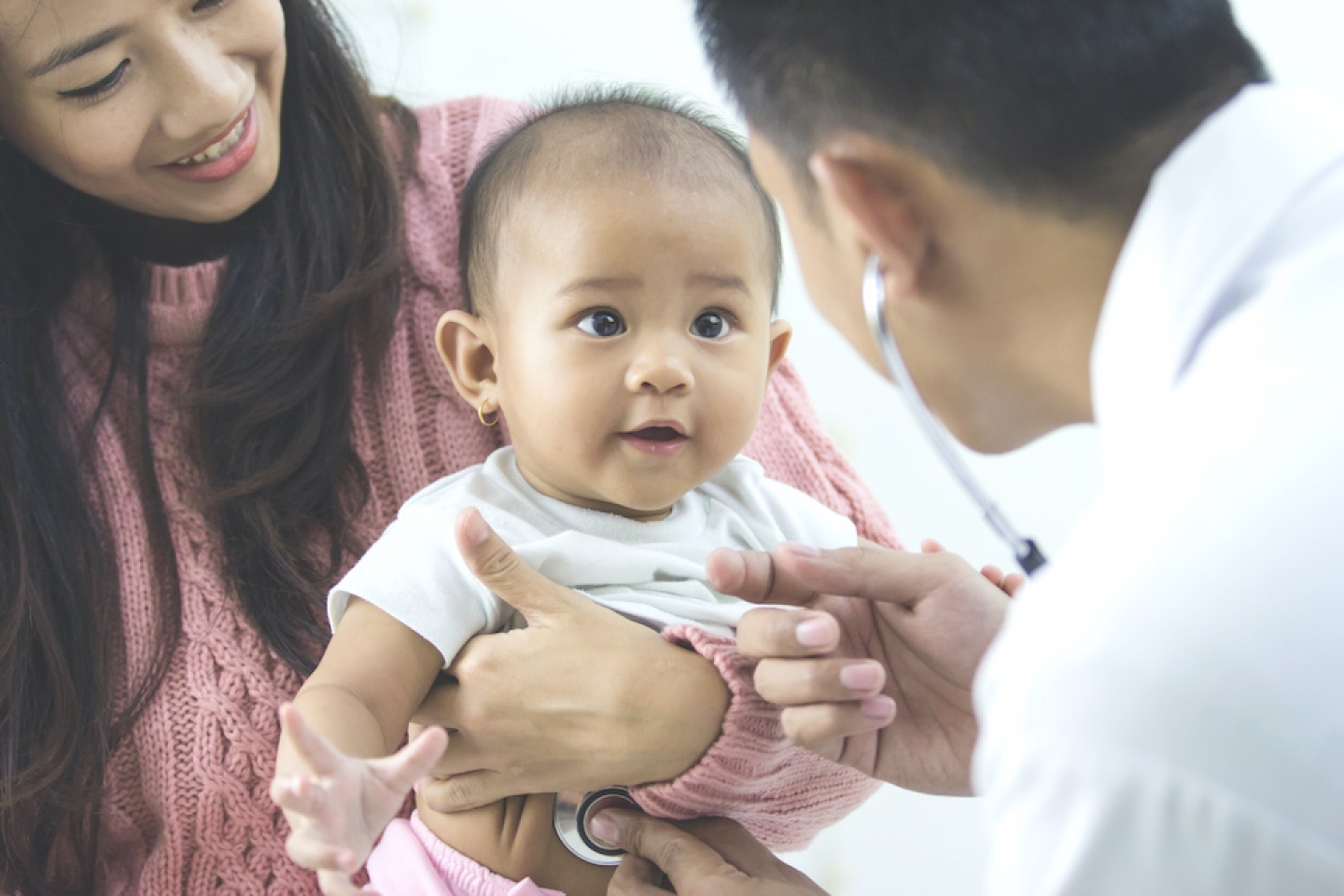 young baby with mom and doctor