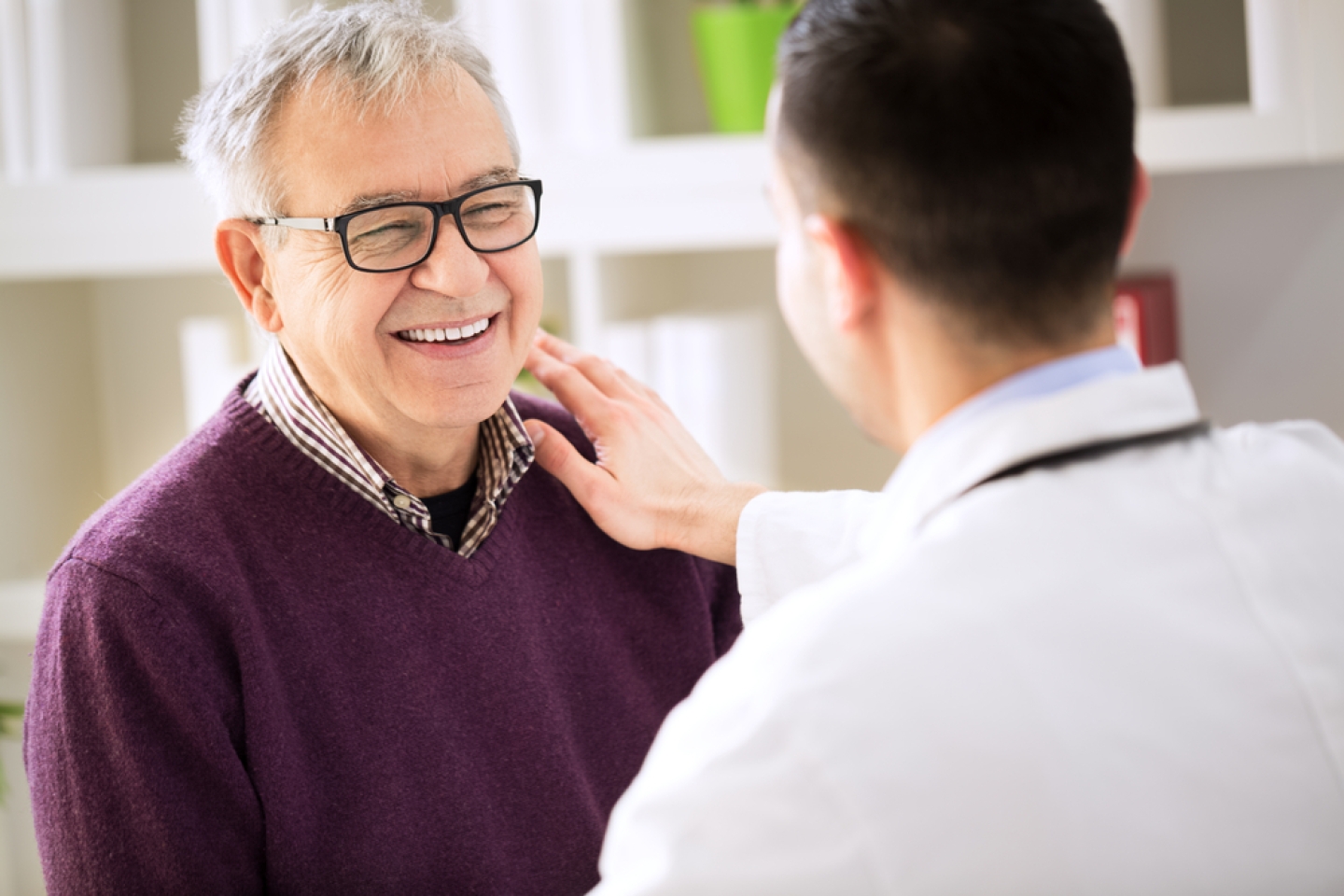 Smiling happy old patient visit doctor