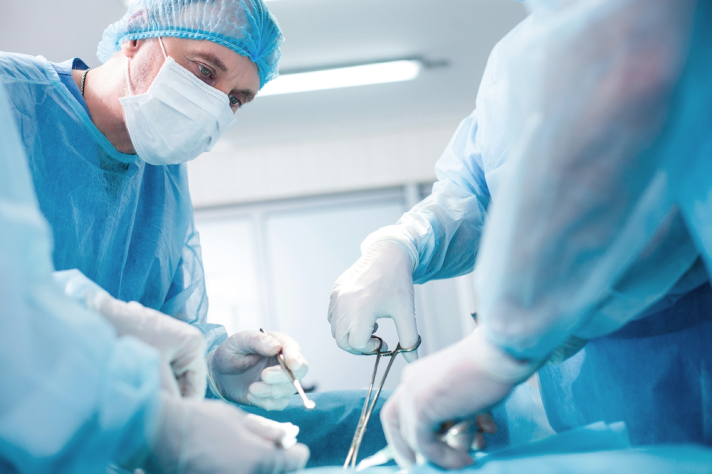 Experienced surgical doctor is operating on a patient
