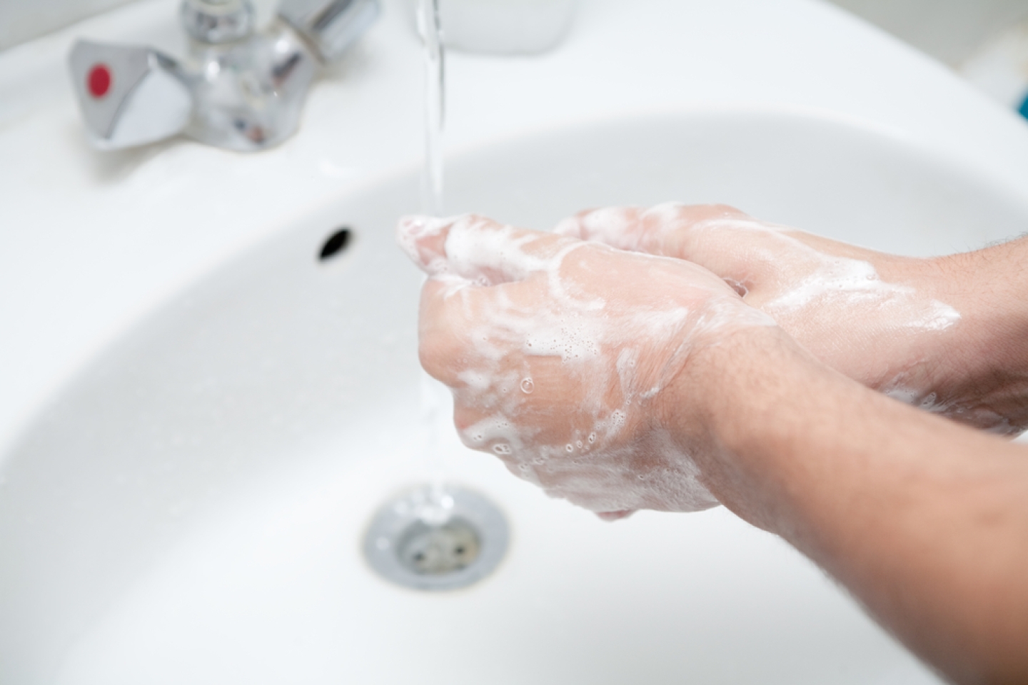 Image of man washing his hands