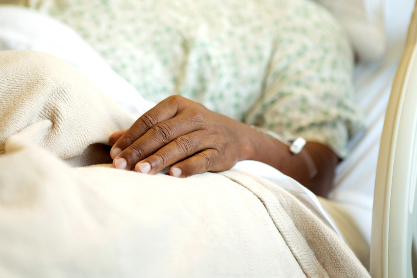 African American man in a hospital bed.