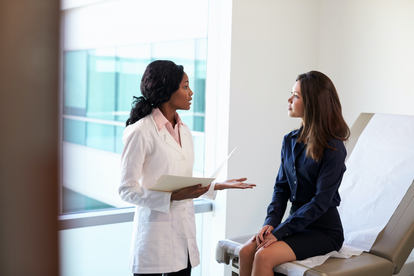 doctor speaks with patient