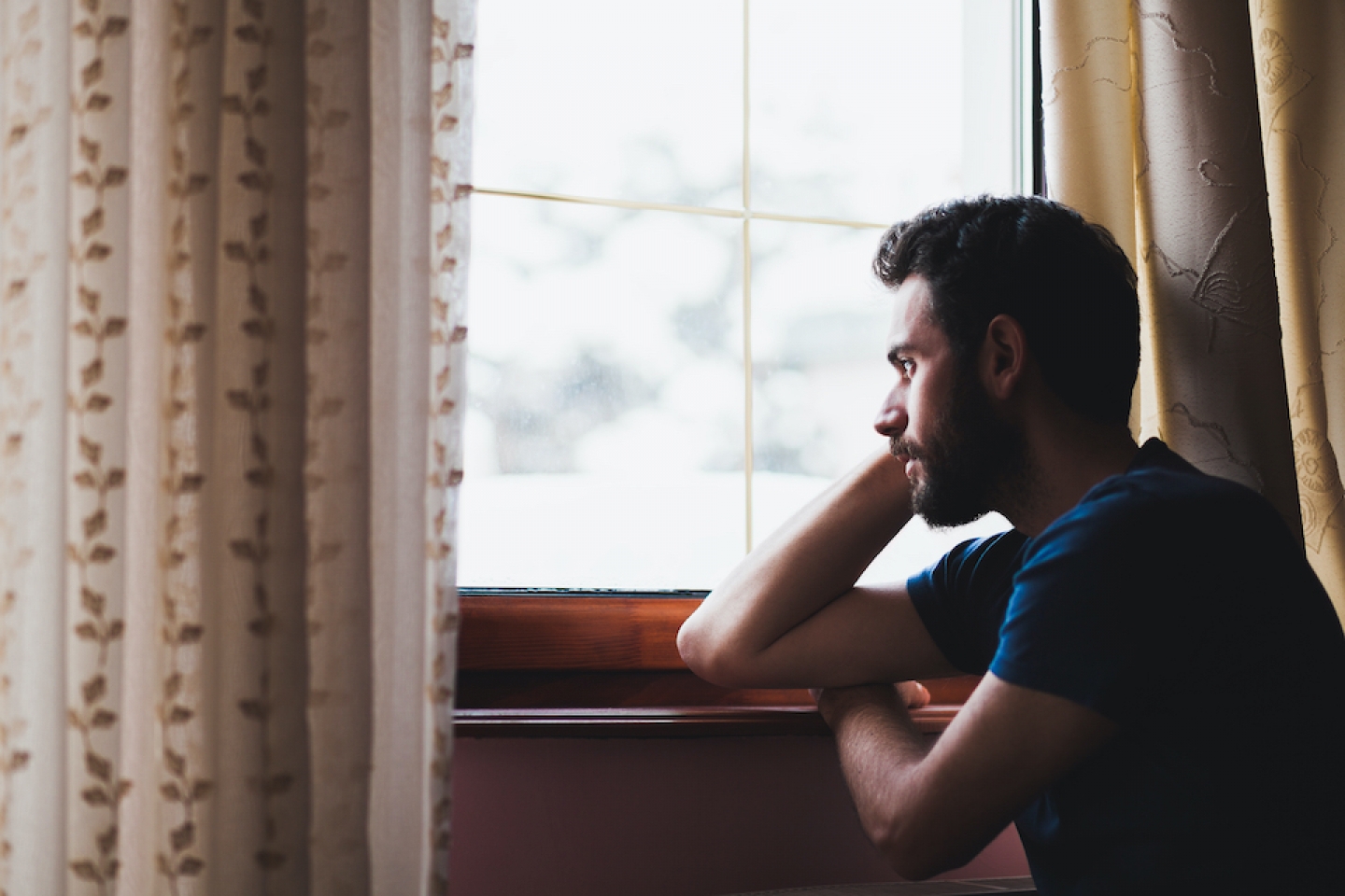 man looking out the window