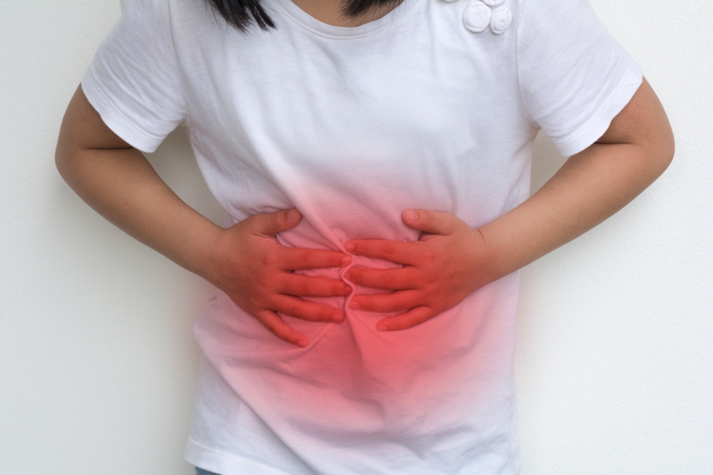 girl holding her stomach due to pain