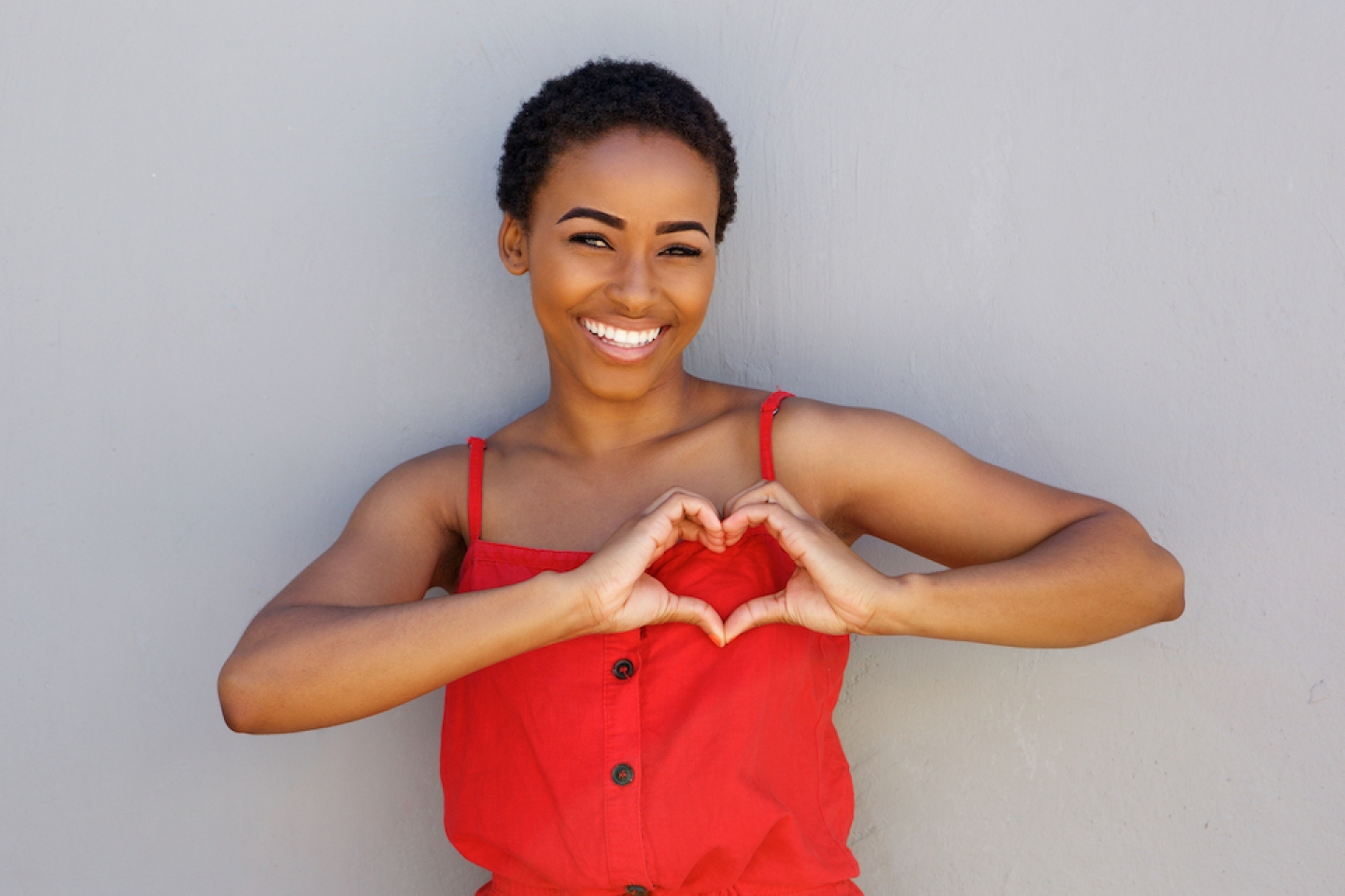 black women making heart sign with her hands