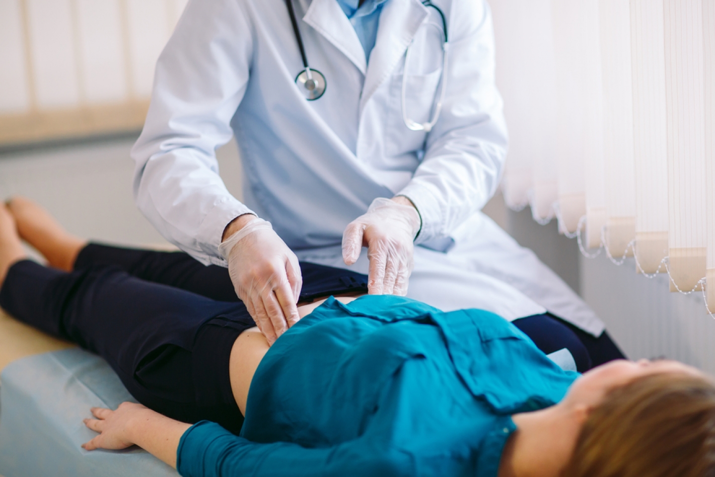 doctor examines patient