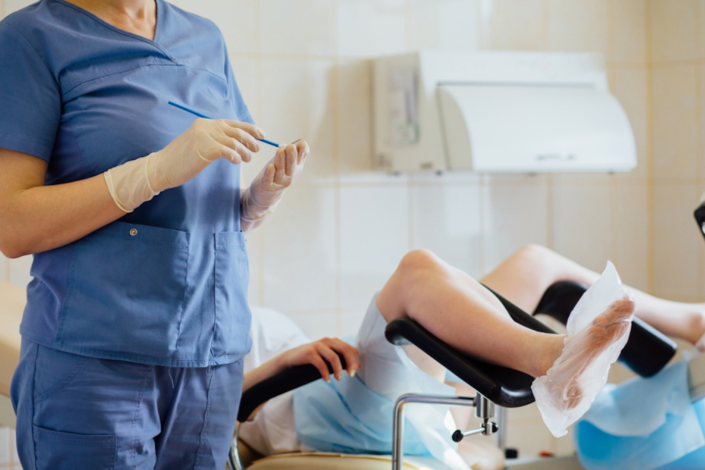 Unrecognizable female doctor gynecologist working with patient. Vaginal Smear.