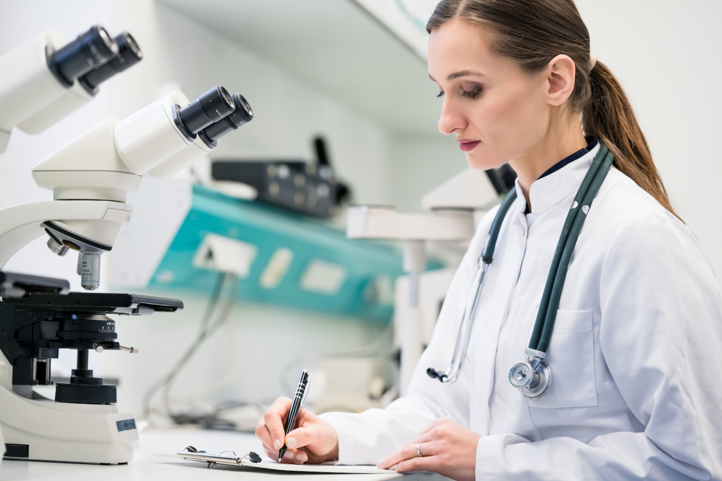 doctor writing results on clipboard