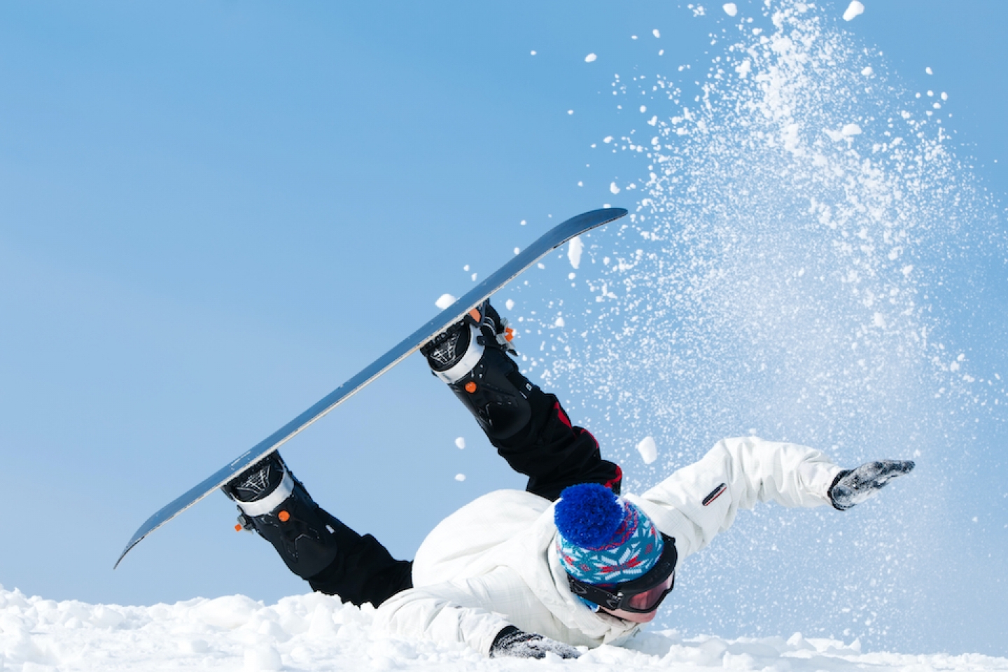 person falling while snowboarding