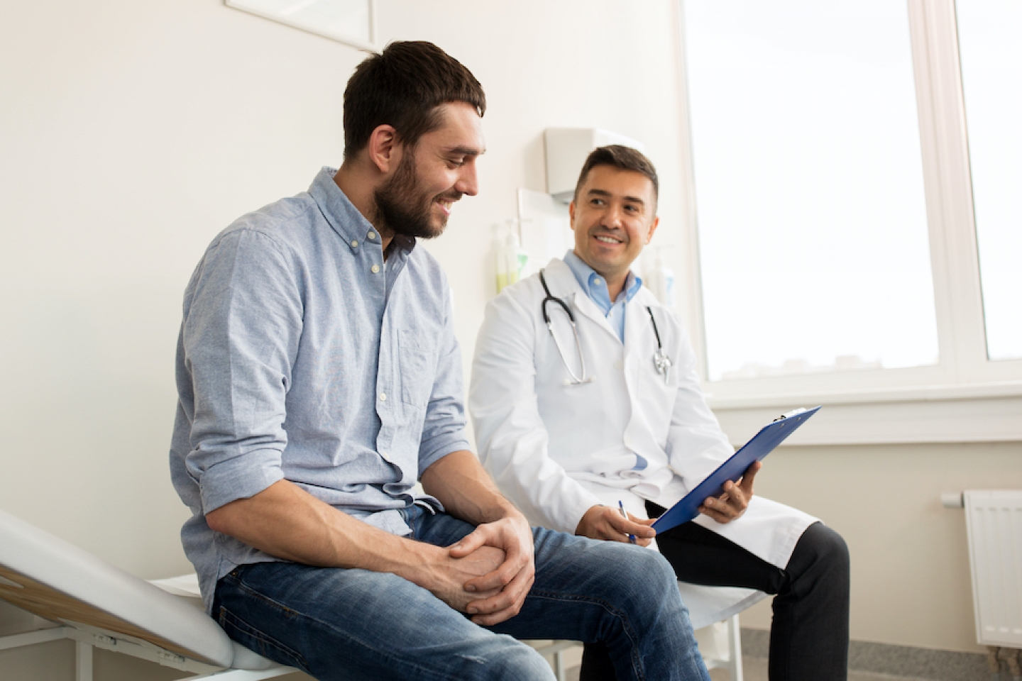 man smiling with doctor