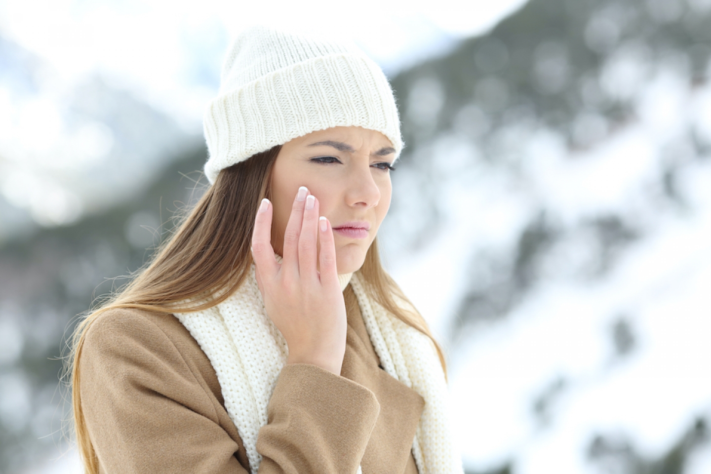 woman touching face in the cold weather