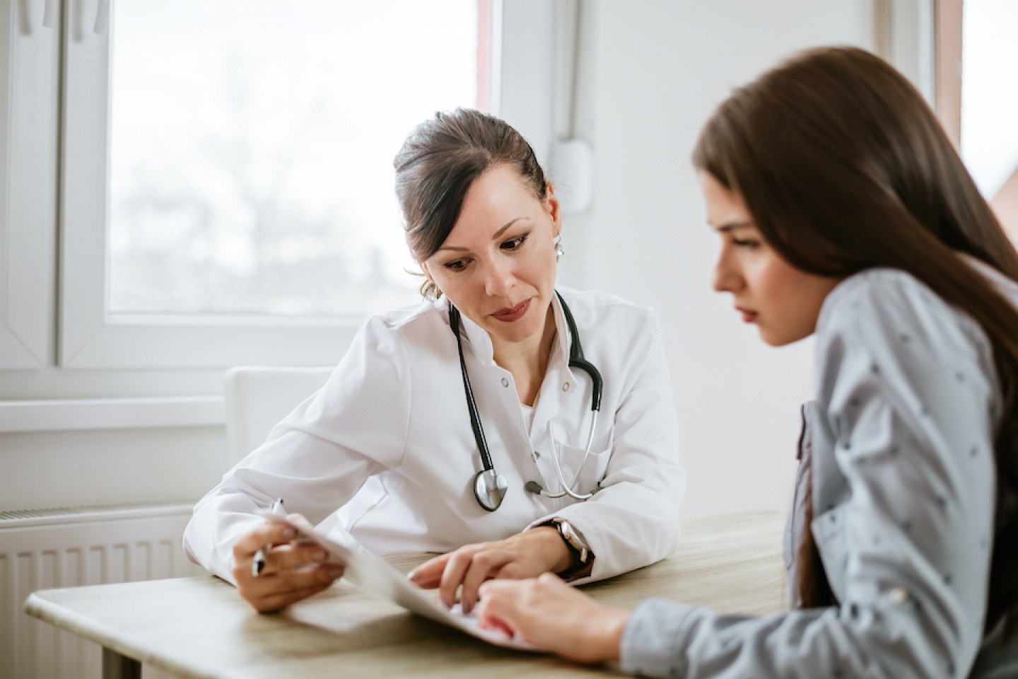 woman consulting with doctor on her results