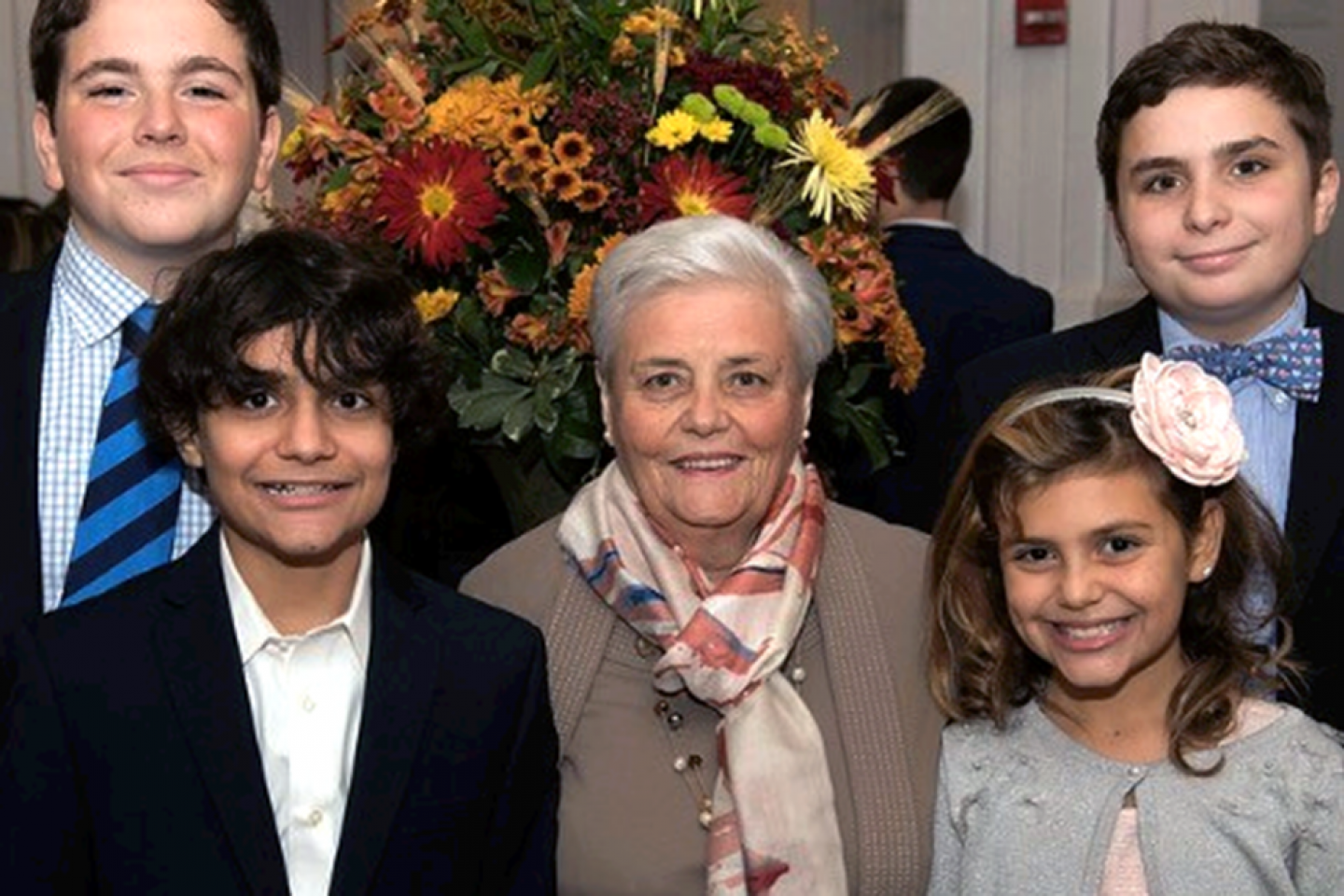 Domenica Devito, center, poses with her grandchildren. She has been cancer-free for two years after receiving treatment at Weill Cornell Medicine. Photo of Domenica Devito with her grandchildren.