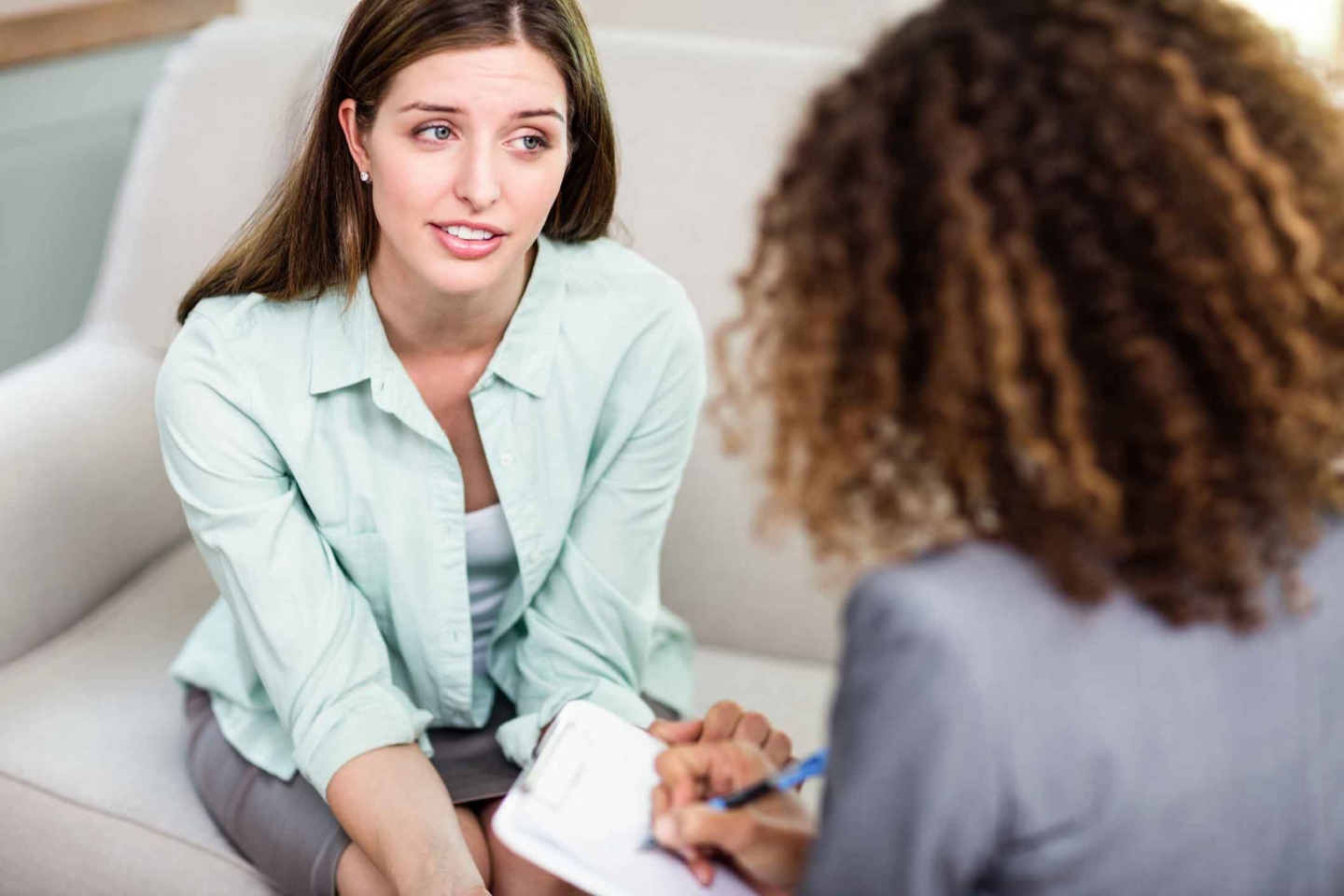 Young woman talking to therapist