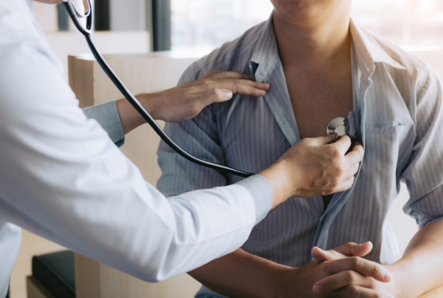 Doctor checking patient's heart