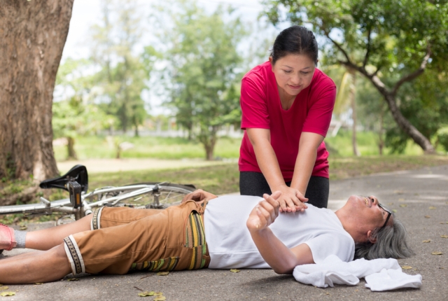 Asian senior female use hand pump on chest of Asian patient man, unconscious patient treatment, cardiopulmonary resuscitation, cpr, heart attack, Acute myocardial infarction