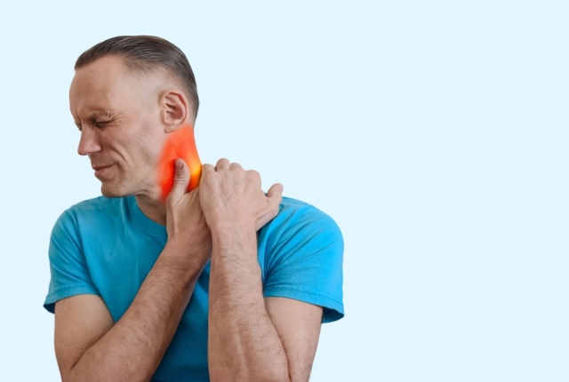 Young man feeling pain and massaging red sore neck, Male clutching sore neck, graphic red area emphasizes inflammation and muscle discomfort.