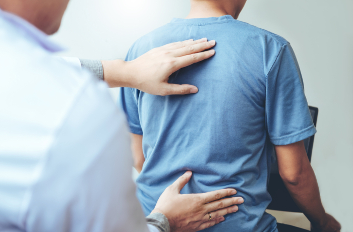 Doctor checking patients's back
