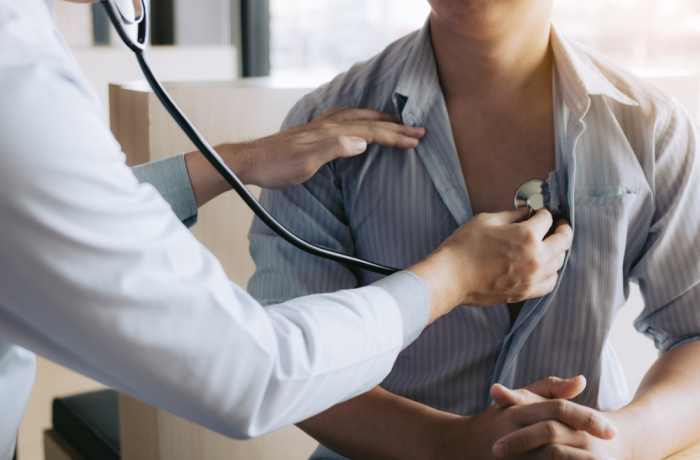 Doctor checking patient's heart