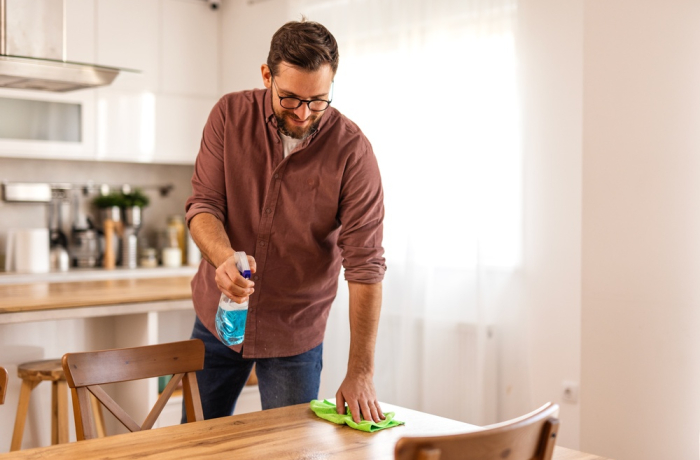 A man cleaning the table