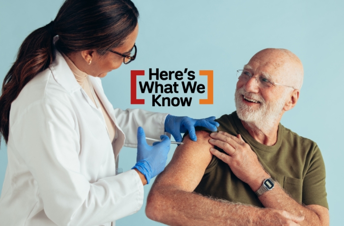 doctor administering vaccine to older man