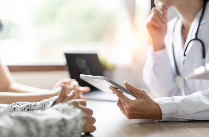 Doctor with patient looking at tablet