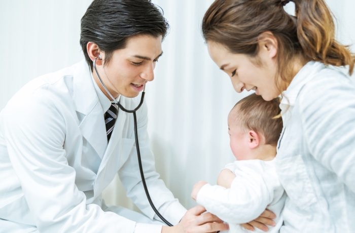 Doctor and mother and child in a consultation room. Pediatrician.