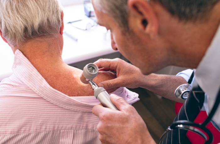 doctor inspecting patient's skin