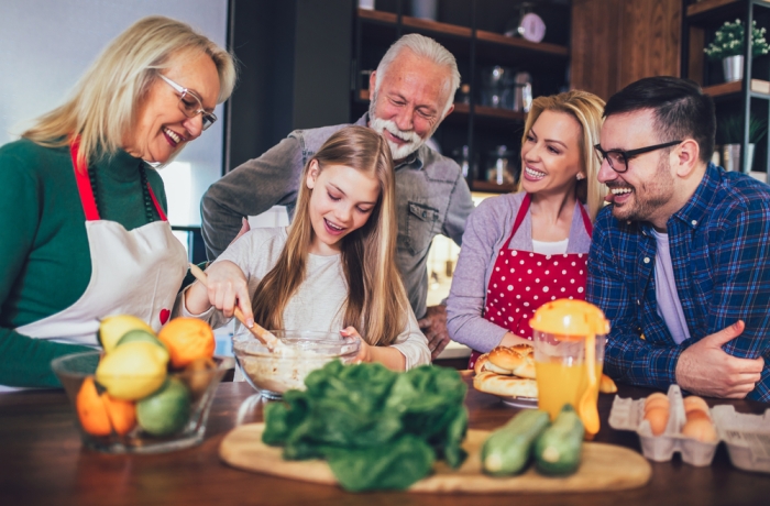 Happy family cooking together at home and smiling