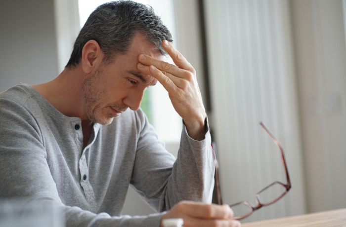 Portrait of man having migraine