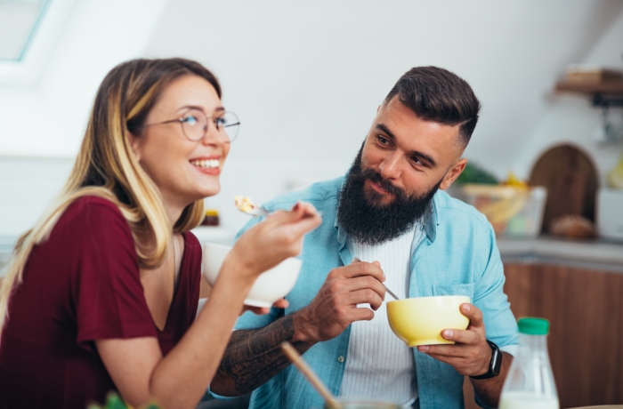 Shot of a young couple enjoying breakfast in the kitchen