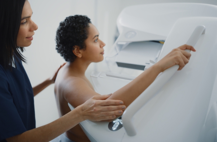 Female Patient with Curly Hair Undergoing Mammography Scan