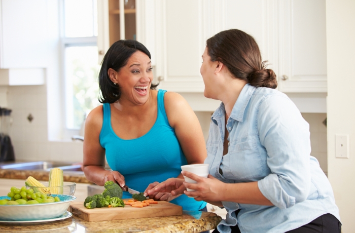 Two Women Preparing Vegetables in Kitchen