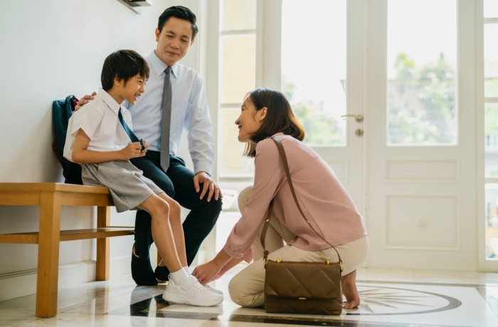 family with child getting ready for school